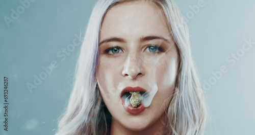 Smoking, weed and woman with marijuana in mouth with addiction to plant with thc and bud. Drugs, smoke and portrait of person with cannabis, herbs and abuse of legal substance burning on lips photo