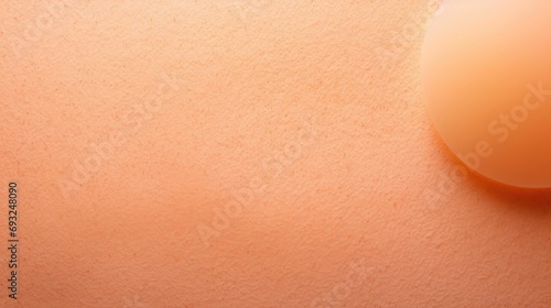 Closeup of a minimalist pastel Peach Fuzz background, with a slight gradient effect towards the center. photo