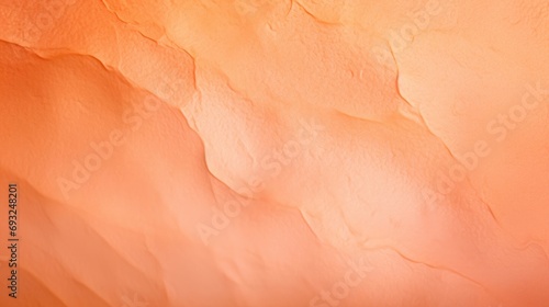 Closeup of a Peach Fuzz colored backdrop featuring a gradient effect with lighter and darker shades.