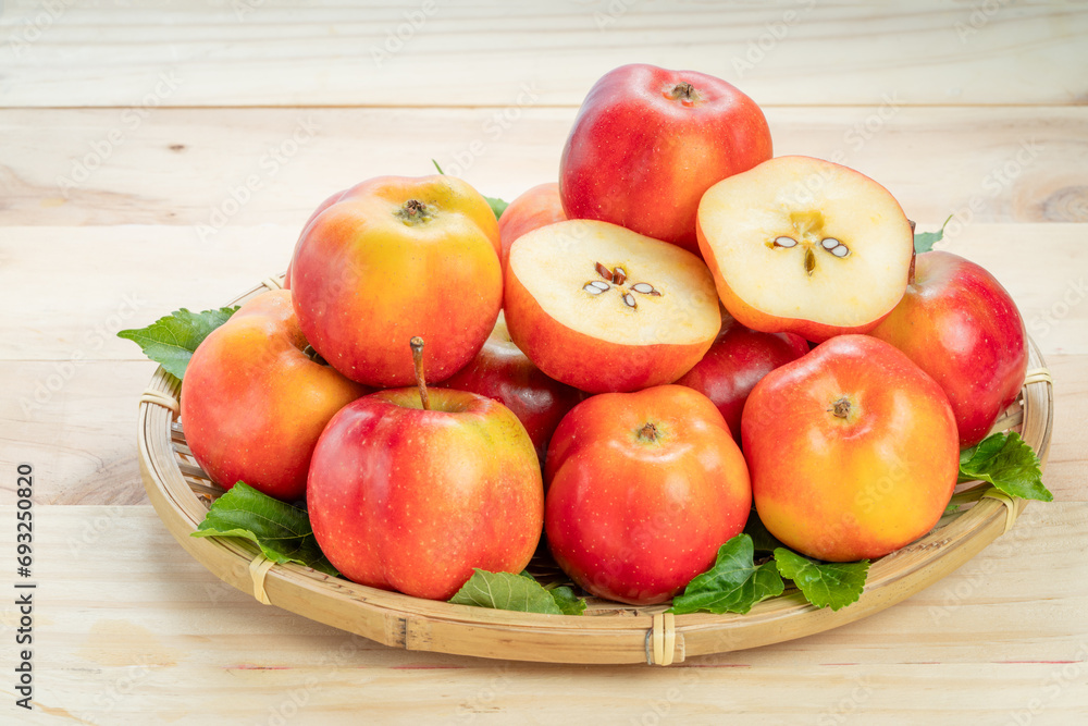 Sweet red star apple in basket on wooden table background, Sweet red star apple in basket on wooden table background,