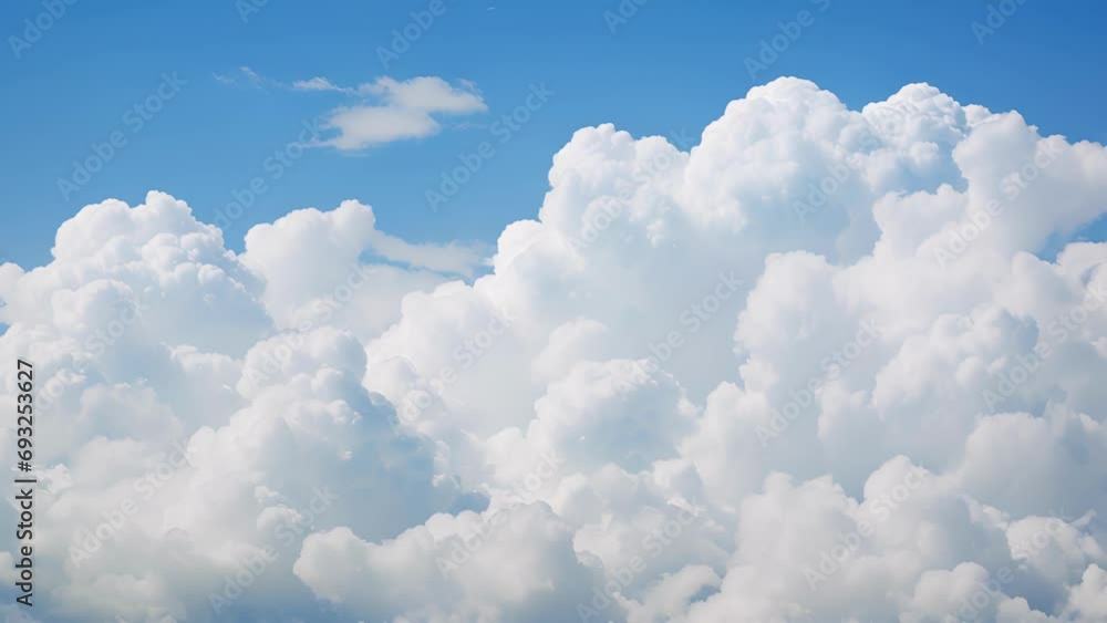 A of fluffy white cumulus clouds against a vivid blue sky A of fluffy white cumulus clouds against a vivid blue sky