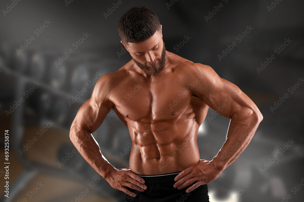 Handsome bodybuilder with muscular body in gym Handsome bodybuilder with muscular body in gym