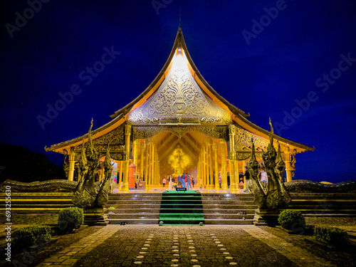 Wat Sirindhorn Wararam glowing temple in Ubon, Thailand photo