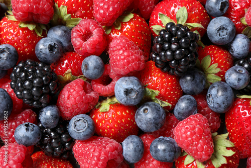 Assortment of fresh ripe berries as background  top view