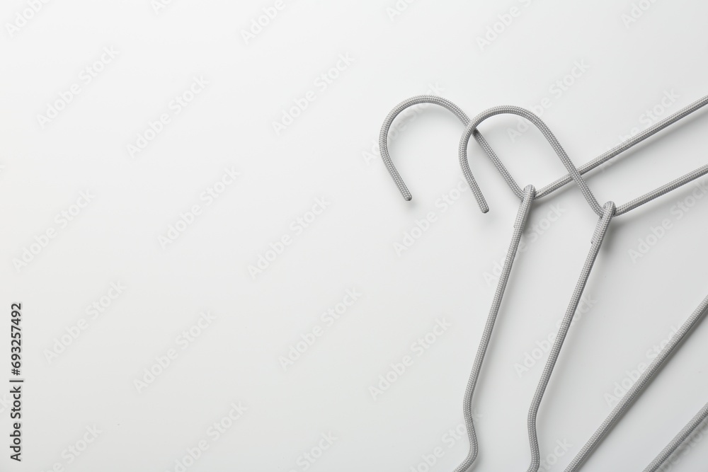 Hangers on white background, top view. Space for text Hangers on white background, top view. Space for text