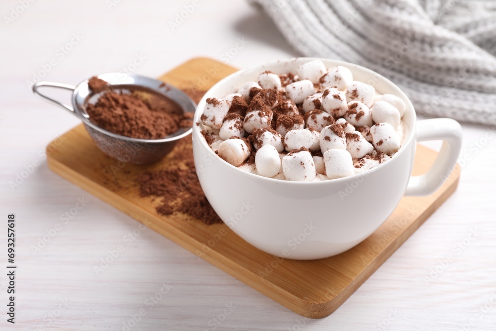 Cup of aromatic hot chocolate with marshmallows and cocoa powder on light wooden table, closeup Cup of aromatic hot chocolate with marshmallows and cocoa powder on light wooden table, closeup