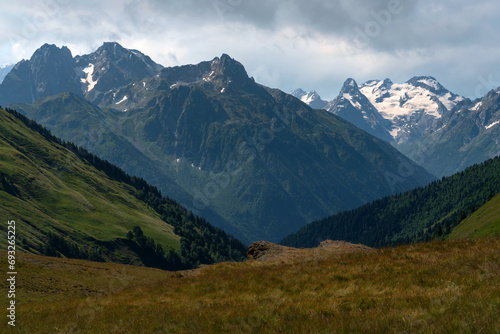 View of the peaks of the North Caucasus mountains near the Arkhyz ski resort on a sunny summer day, Karachay-Cherkessia, Russia