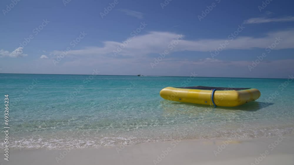 Yellow air float in ocean with boat in background 4K Yellow air float in ocean with boat in background 4K