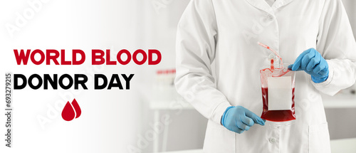Banner for World Blood Donor Day with doctor holding blood pack for transfusion
