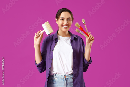 Young woman with paint brus...