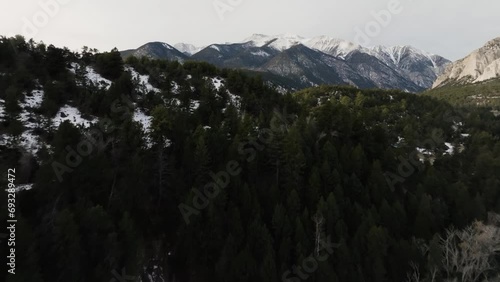 Drone over a hill with pine trees to expose Mount Antero in the Rocky Mountains in Colorado photo