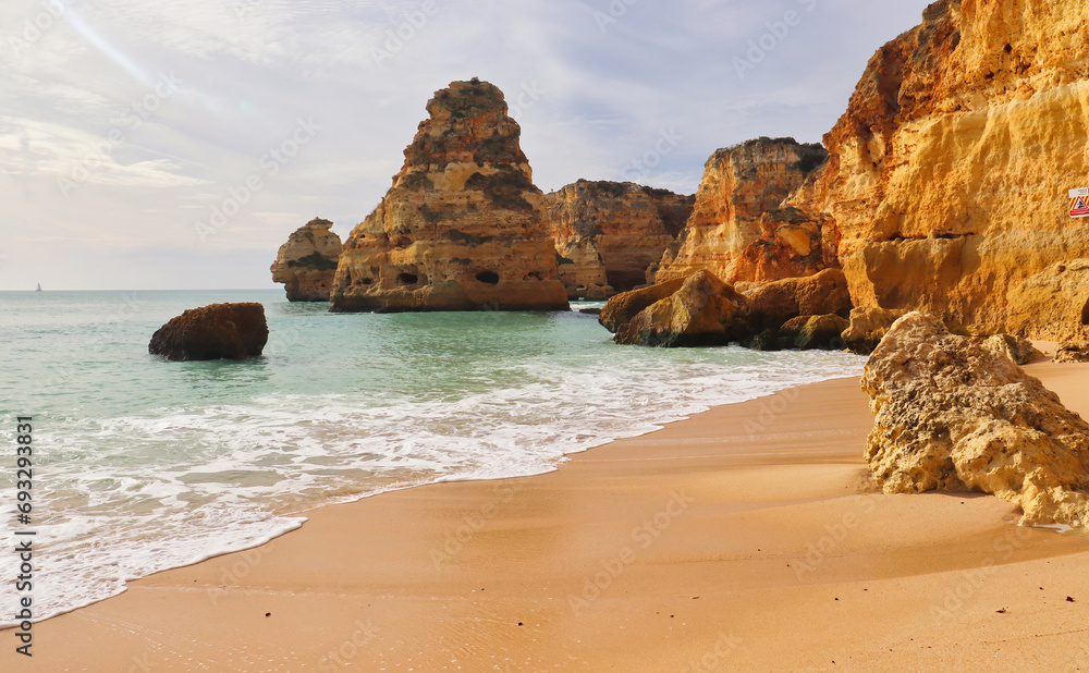 Sandy beach with large rocks on a gorgeous winter day in southern Portugal.