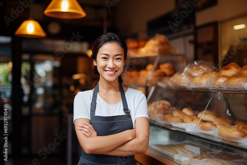 Young Asian entrepreneur in front of her bakery shop.