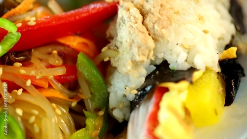 한국 음식 잡채와 하얀색 쌀 밥위에 올려진 다진 참치를 올린 누드 김밥이 먹음직스러운  photo