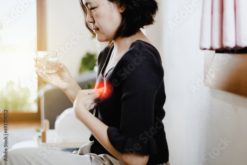 Gastroesophageal reflux disease,Because the esophageal sphincter that separates the esophagus and stomach dysfunction,Asian female having or symptomatic reflux acids photo