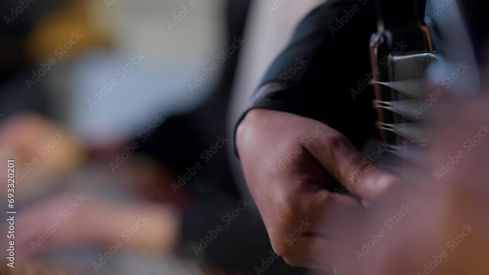 A woman playing on Zither in the theatre beside a man playing a drum static shot, close up A woman playing on Zither in the theatre beside a man playing a drum static shot, close up