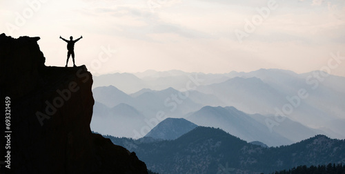 The achievement of the mountain climber who views the magnificent mountain ranges from a high place photo