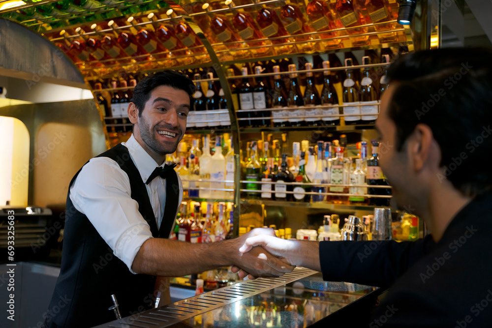 Bartender and customer at night club.