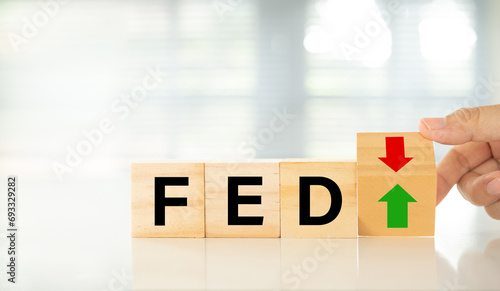 Federal Reserve bank (FED) concept. words of fed and arrow point up or go down on wooden block. photo
