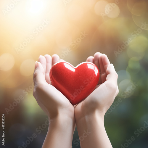 hands holding red heart over bright background  health care  hope  life insurance concept  World Heart Day  world health day 