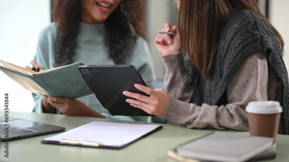 Two business workers talking on the smartphone, tablet and using laptop at office. Two business workers talking on the smartphone, tablet and using laptop at office.