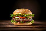 fresh tasty delicious burger with beef patty, lettuce, onions, tomatoes and cucumbers, big fresh hamburger with extra filling on wooden table isolated on dark background with copy space