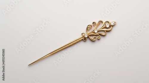 a gold hairpin, capturing its luxurious appearance and intricate detailing, perfectly isolated against a clean white backdrop for a touch of sophistication. © baloch