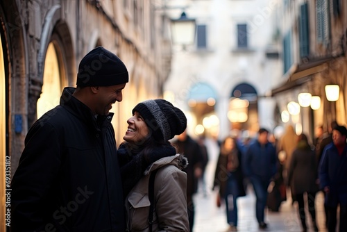 A young couple, deeply engaged in eye contact, enjoys a romantic walk in the city, portraying love and togetherness in their dating journey.