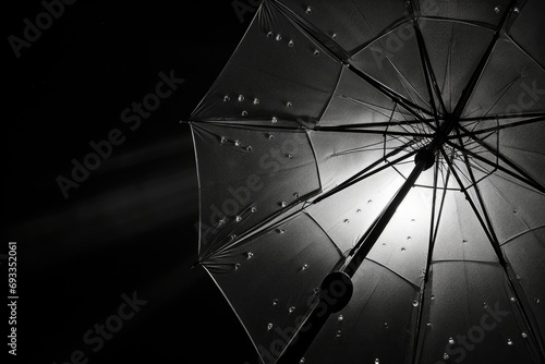 A black and white photo of an open umbrella. Can be used for various purposes