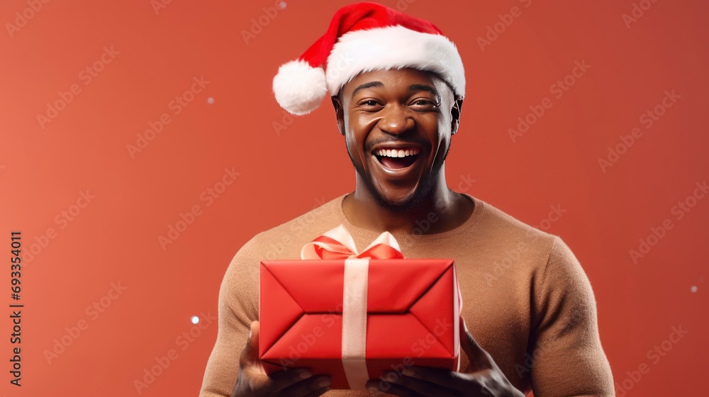 Try to guess what's inside. Happy black man in Santa hat shaking Christmas gift, listening to what is shaking in gift box, monochrome background, copy space - generative ai Try to guess what's inside. Happy black man in Santa hat shaking Christmas gift, listening to what is shaking in gift box, monochrome background, copy space - generative ai