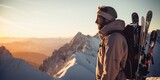 A man standing on top of a snow covered mountain. Perfect for adventure and outdoor exploration themes