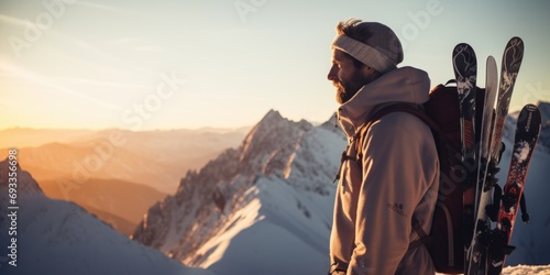 A man standing on top of a snow covered mountain. Perfect for adventure and outdoor exploration themes