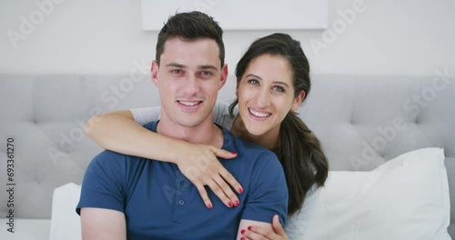 Smile, couple and kiss cheek in bedroom at home, care and together in the morning. Face portrait, man and woman in romantic connection in bed, happy in healthy relationship and love on valentines day photo