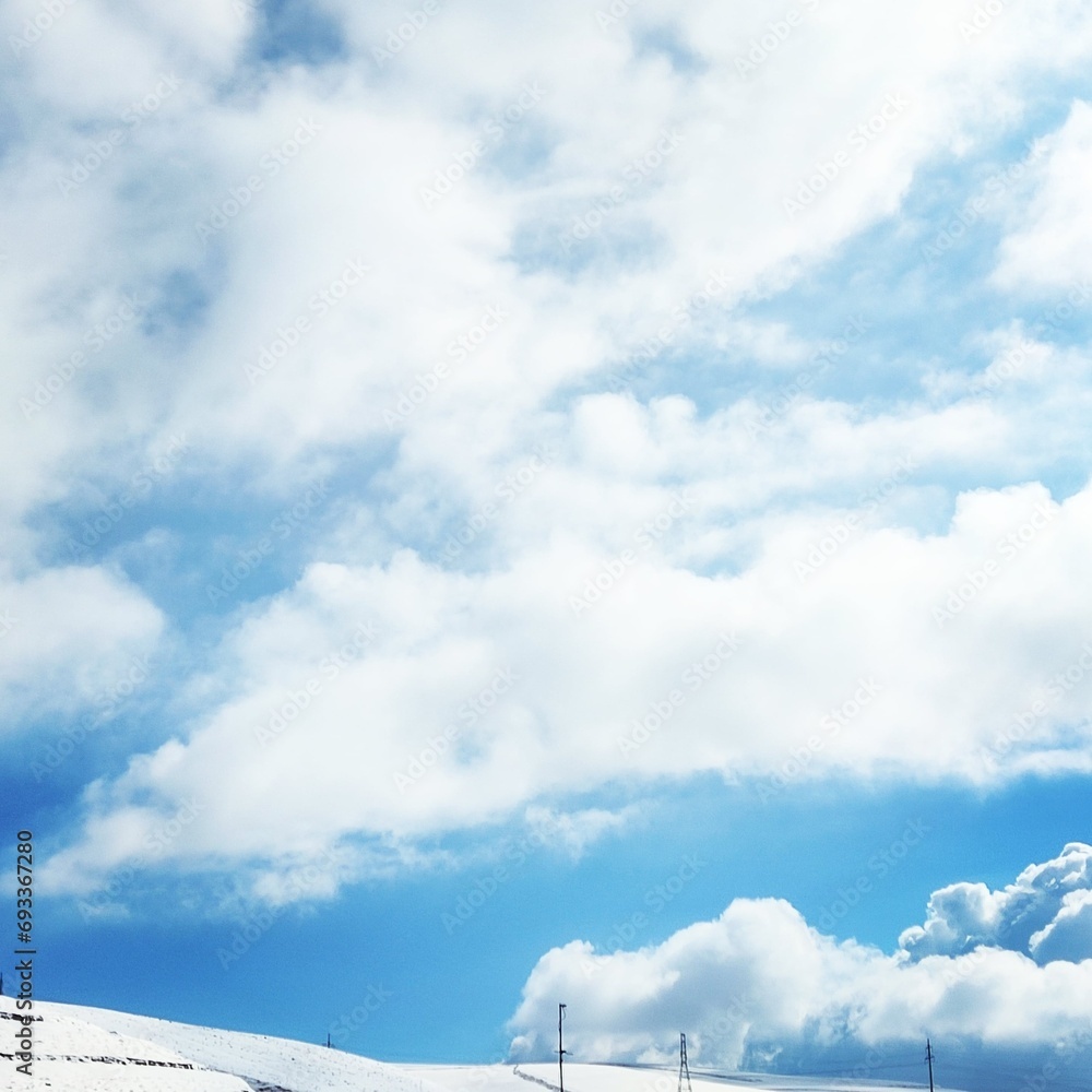 Obraz premium white clouds over winter blue sky