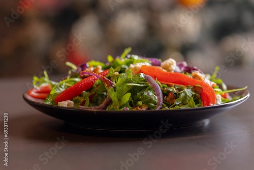 Winter Salad with Rucola, Red Onion, Canned Red Pepper, and Walnuts Close-Up 