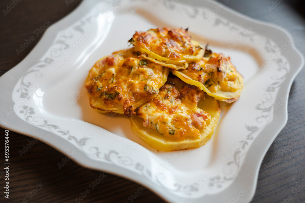 home cooking showcasing cut potatoes generously filled with mouthwatering stuffing on a white plate