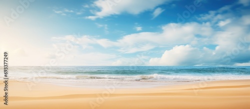 Summer beach blur defocused background. tropical with golden sand, turquoise ocean blue sky with white clouds on bright sunny landscape for holidays product presentation.