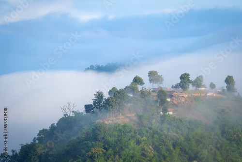 Beautiful natural scenery with a sea of mist around mountain peaks in the morning on the hills amidst Thailand's lush green forests ecologically fertile. photo