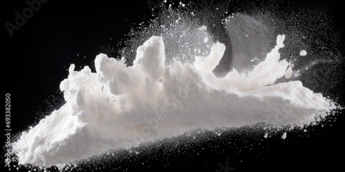 A pile of white powder on a black background. Can be used in various contexts photo