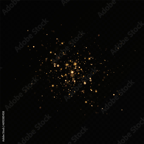 Golden sequins glow with many lights. Glittering dust. Luxurious background of golden particles.