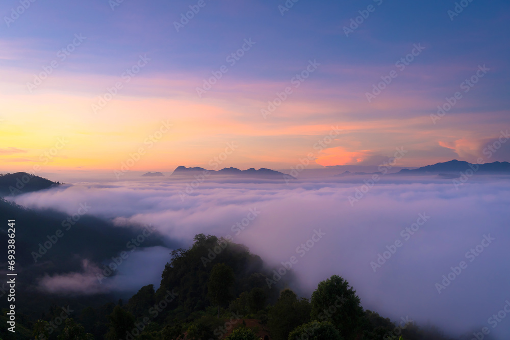 Beautiful natural scenery with a sea of mist on mountain peaks in the morning on the hills at Glo Selo Viewpoint at Mae Hong Son, Northern Thailand.