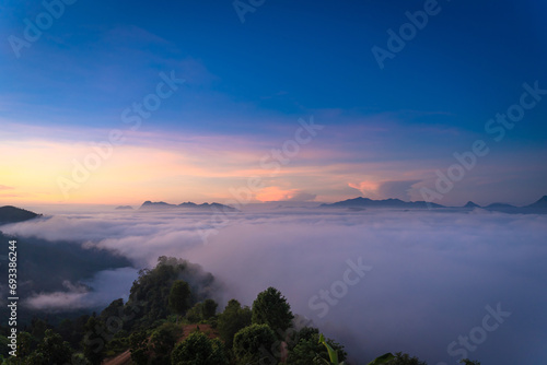 Beautiful natural scenery with a sea of mist on mountain peaks in the morning on the hills at Glo Selo Viewpoint at Mae Hong Son, Northern Thailand.