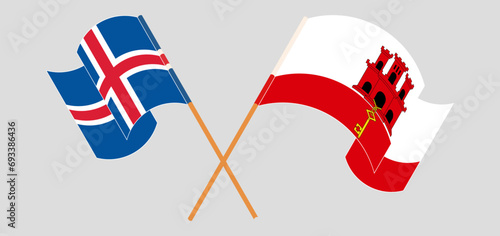 Crossed and waving flags of Iceland and United Kingdom
