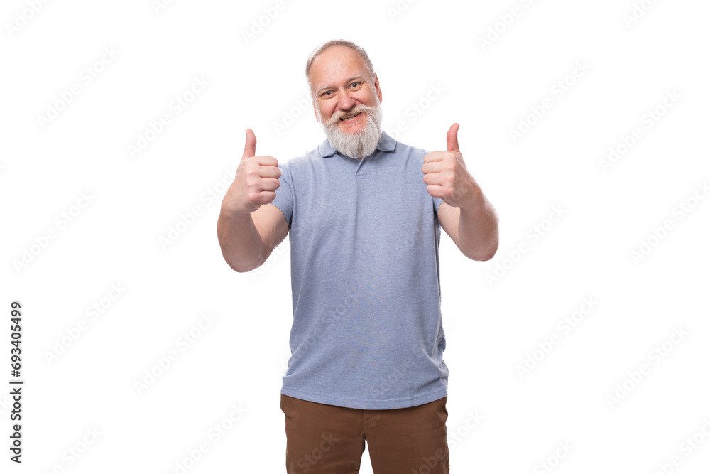 Fototapeta premium a handsome elderly man with a gray beard and mustache in a T-shirt is full of energy and health