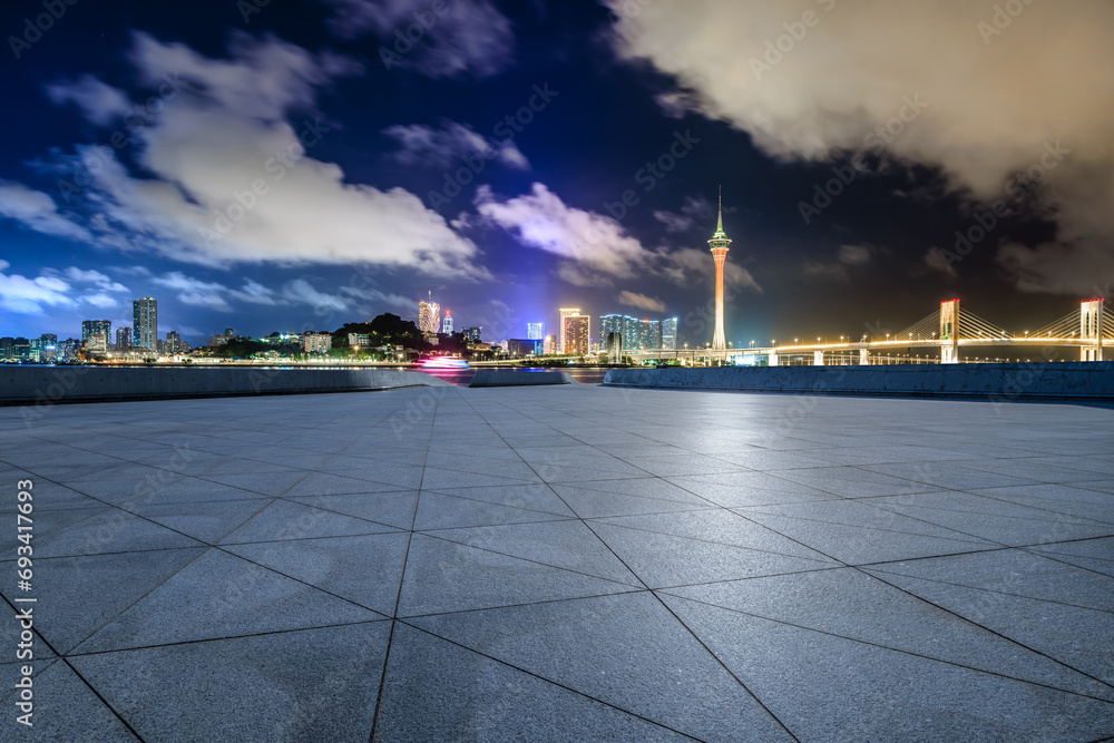 Empty square floors and Macau skyline with modern buildings at night