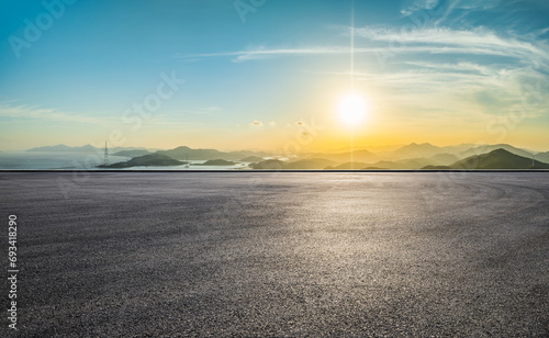 Asphalt road platform and beautiful coastline with mountain natural landscape at sunset. High Angle view.