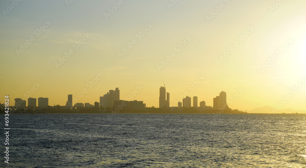 Silhouette of Pattaya city with seaside view and sunset sky background, Travel background