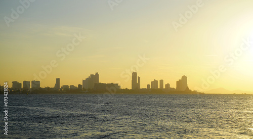 Silhouette of Pattaya city with seaside view and sunset sky background, Travel background