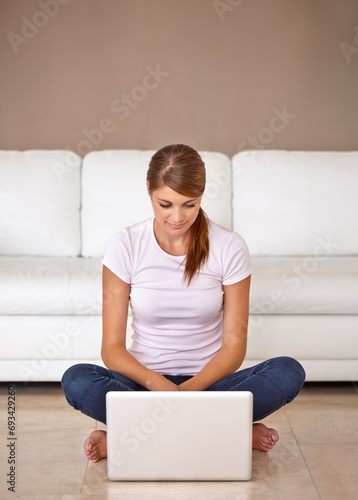 Woman, remote work and laptop on floor in home to update blog post, social media and reading digital news subscription. Freelancer, computer and relax on ground for online shopping, email or research