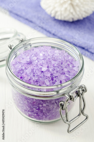 Glass jar with purple lavender crystal bath salt (foot soak). Homemade pedicure, spa and beauty treatment recipe.